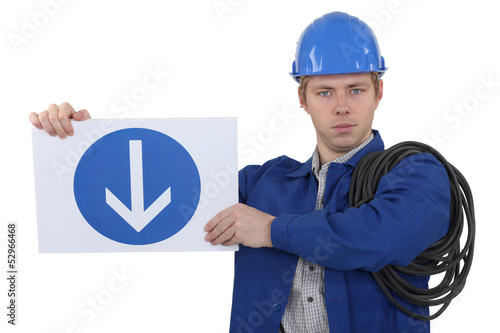 Photo: Electrician holding road sign Electrician holding road sign