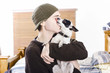 Small dog kissing his male owner. Pet love
