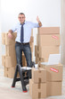 Foto: Man surrounded by cardboards Man surrounded by cardboards