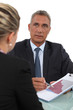 Boss explaining financial results to female employee