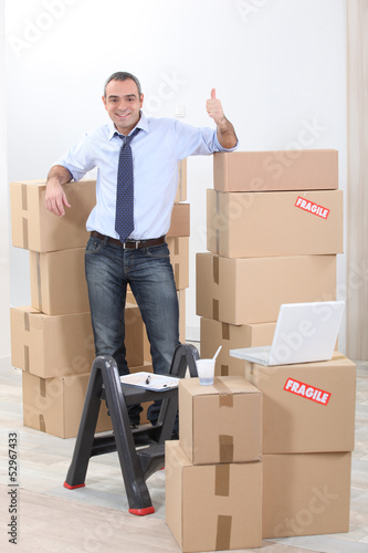Photo: Man surrounded by cardboards Man surrounded by cardboards