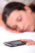 Photo: Woman asleep next to mobile telephone Woman asleep next to mobile telephone