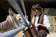 Photo: female farmer feeding donkey female farmer feeding donkey