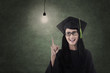 Beautiful nerd in graduation gown have idea