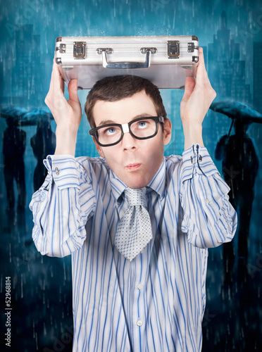 Photo: Businessman in financial storm. Insurance cover Businessman in financial storm. Insurance cover
