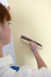 Woman smoothing down wallpaper