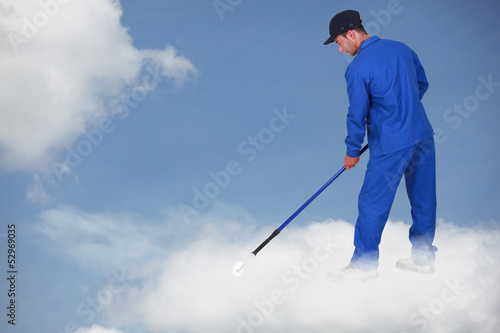 Photo: Photomontage of a worker on a cloud Photomontage of a worker on a cloud