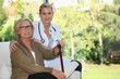Photo: Elderly woman and young female caregiver at home Elderly woman and young female caregiver at home