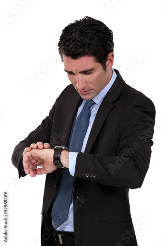 Photo: Businessman checking his watch Businessman checking his watch