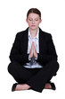 Photo: Young businesswoman meditating Young businesswoman meditating
