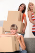 Photo: Three female flat-mates packing boxes Three female flat-mates packing boxes