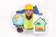 Foto: Tradesman holding a globe and an energy efficiency rating chart Tradesman holding a globe and an energy efficiency rating chart