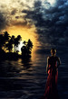 Blonde woman in red dress at sunset