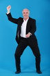 Photo: Strange businessman pretending to ride a horse Strange businessman pretending to ride a horse