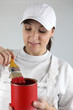 Photo: female painter with red tin of paint and brush female painter with red tin of paint and brush