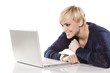 Photo: cute smiling blonde working on a laptop on white background cute smiling blonde working on a laptop on white background