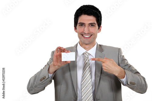 Photo: Businessman pointing at card Businessman pointing at card