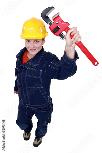 Photo: Female worker with an adjustable pipe wrench Female worker with an adjustable pipe wrench