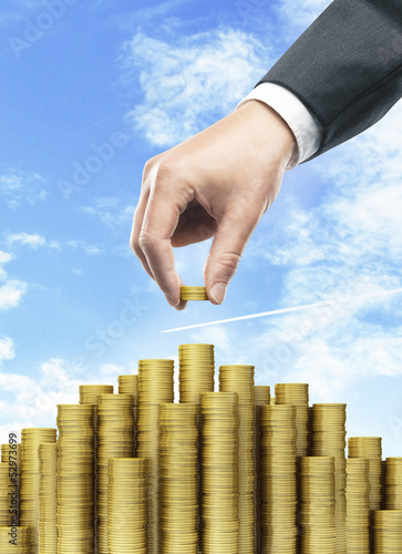 Photo: Hand put coins Hand put coins
