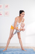 Healthy mother and baby making gymnastics