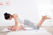 mother does gymnastics with her baby