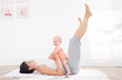 mother does gymnastics with her baby