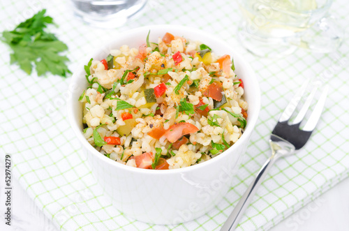 Photo: white bowl of salad with bulgur, zucchini, tomatoes and parsley white bowl of salad with bulgur, zucchini, tomatoes and parsley