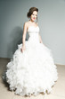 Standing young bride in white dress