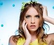 Foto: Portrait of a young beautiful girl wearing may-lily chaplet Portrait of a young beautiful girl wearing may-lily chaplet