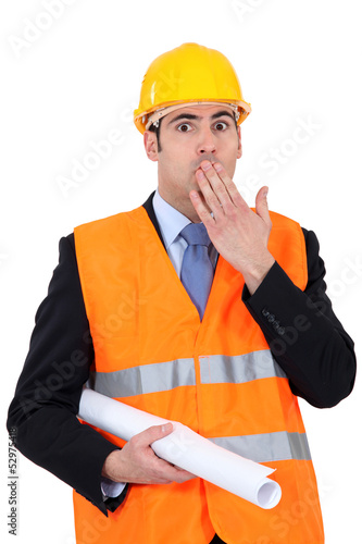 Photo: construction businessman putting a hand on his mouth construction businessman putting a hand on his mouth