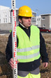 Workers with metal ruler