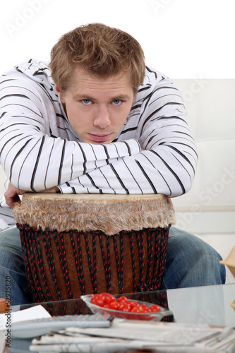 Photo: Man with his arms on his drum Man with his arms on his drum