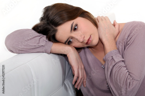 Photo: Sad woman sitting on a sofa Sad woman sitting on a sofa