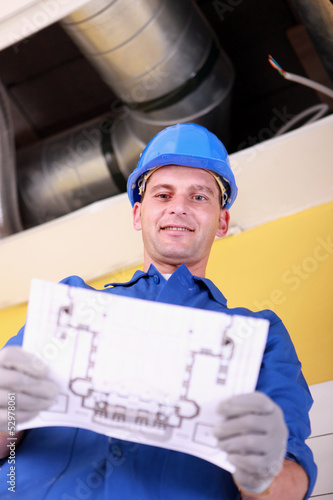 Photo: Engineer with a heating plan Engineer with a heating plan
