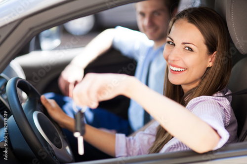 Photo: Young woman showing car keys Young woman showing car keys