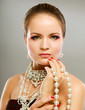 Portrait of pretty young woman with beads and bangle