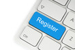 Blue register button on keyboard close-up.