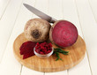 Sliced beetroot on board on wooden table close-up