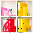 White office shelves with different stationery, close up