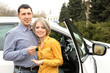 Photo: Portrait of happy beautiful couple with car keys, standing near Portrait of happy beautiful couple with car keys, standing near