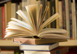 pile of books, one open, selective focus