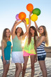 Four Happy Girls On The Beach.
