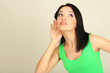 Girl overhears on grey background