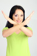 Girl showing stop sign on grey background