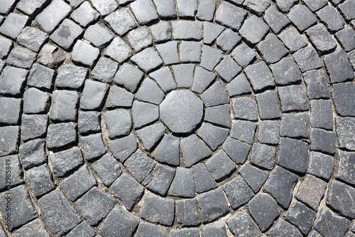 Photo: The roadway paved by a grey granite, background The roadway paved by a grey granite, background