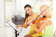 preteen girl play violin under teacher's instructions