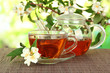 Cup of tea with jasmine, on bamboo mat, on bright background