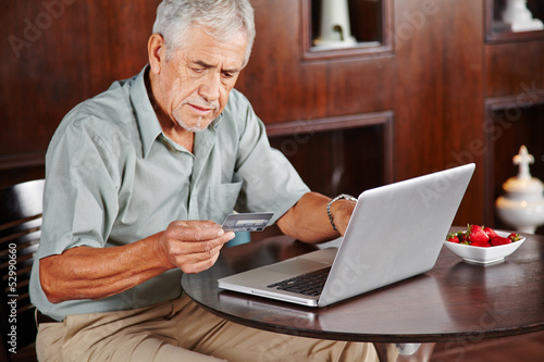 Photo: Senior bezahlt mit Kreditkarte im Internet Senior bezahlt mit Kreditkarte im Internet