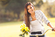 woman with flowers riding a bicycle