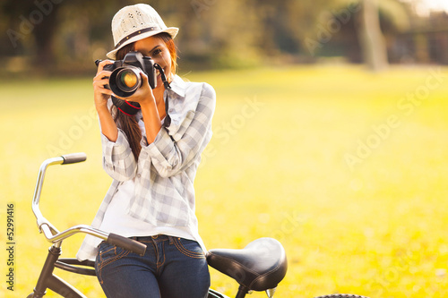 Photo: young woman taking photo outdoors young woman taking photo outdoors